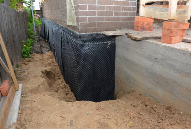 SJ Waterproofing Pros technician performing targeted Exterior Waterproofing assessment in Churubusco, IN